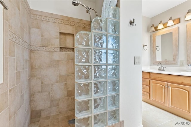 full bathroom with tile patterned flooring, vanity, and a walk in shower