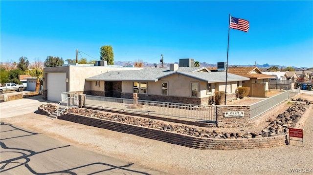 ranch-style home featuring a fenced front yard, stucco siding, a garage, stone siding, and driveway