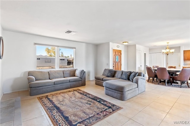 living room with baseboards, visible vents, an inviting chandelier, and light tile patterned floors