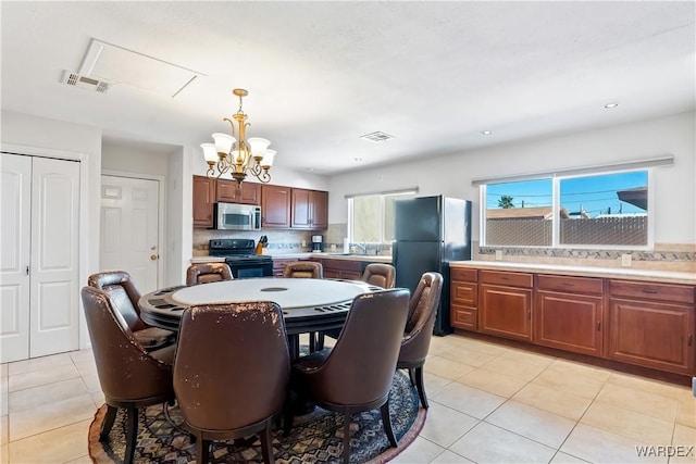 dining room with recessed lighting, visible vents, a notable chandelier, and light tile patterned flooring