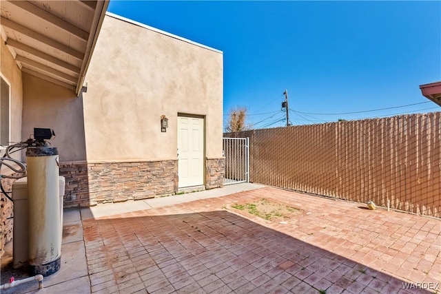 view of patio / terrace featuring a gate and fence