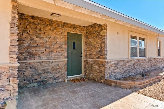 view of exterior entry with stone siding