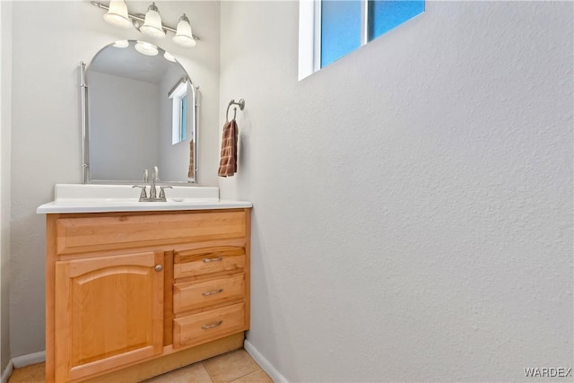 bathroom featuring tile patterned flooring, vanity, and baseboards