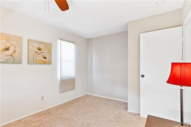 unfurnished room featuring light carpet, ceiling fan, and baseboards