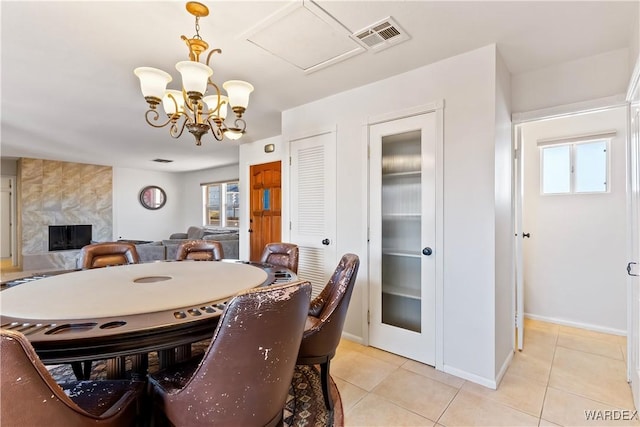 dining space featuring light tile patterned floors, plenty of natural light, and visible vents