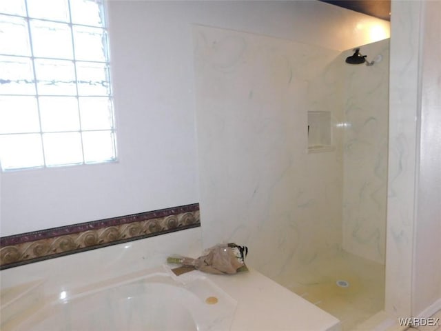 full bathroom with a garden tub and a marble finish shower