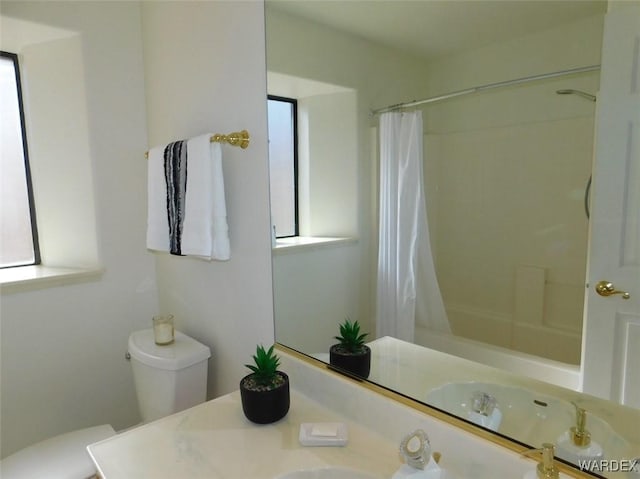 full bathroom featuring toilet, shower / tub combo with curtain, a wealth of natural light, and vanity