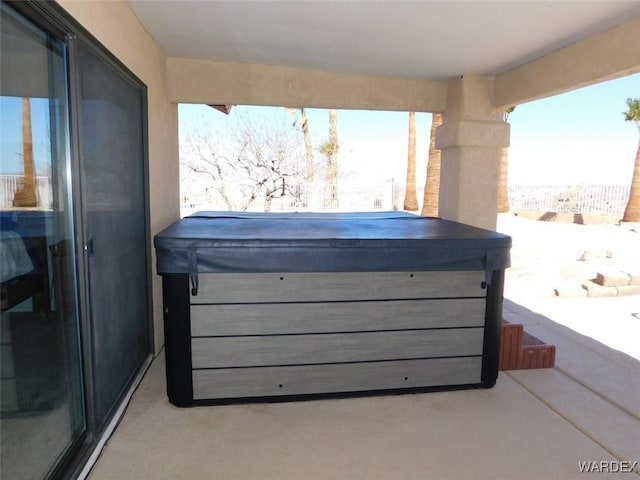 snow covered patio featuring a hot tub