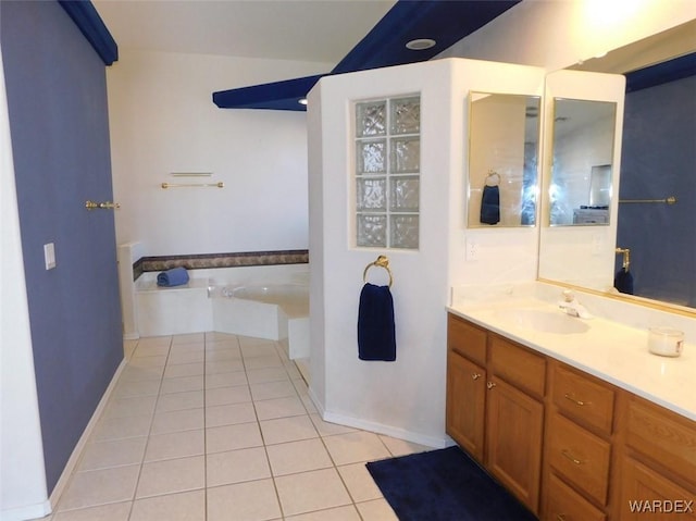 full bathroom featuring a garden tub, tile patterned flooring, and vanity