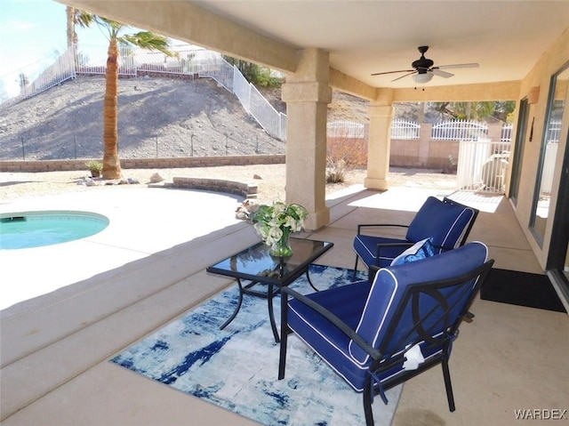 view of patio with a ceiling fan, a fenced backyard, and an outdoor pool