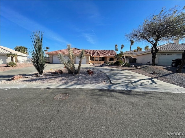 view of front of property featuring stucco siding, a garage, a residential view, driveway, and a tiled roof