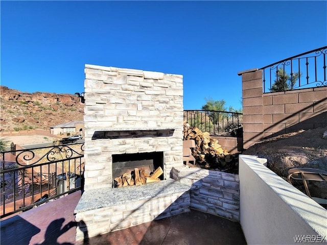 view of patio with an outdoor stone fireplace