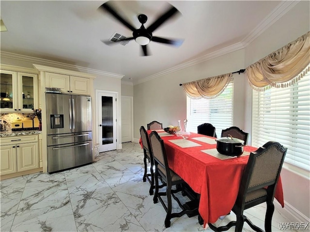 dining room featuring ceiling fan, visible vents, baseboards, marble finish floor, and ornamental molding