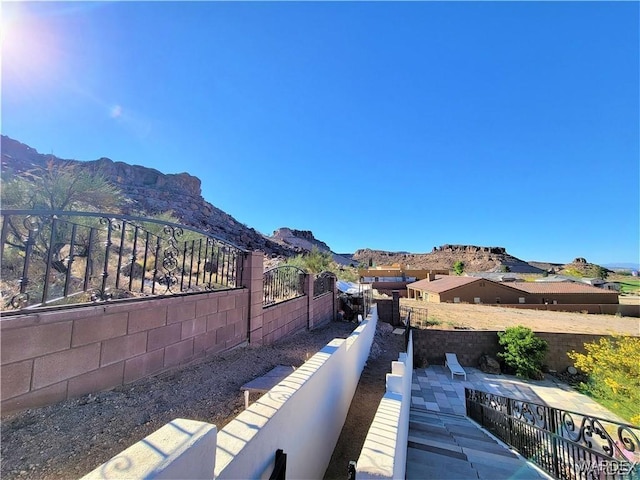 exterior space with fence and a mountain view