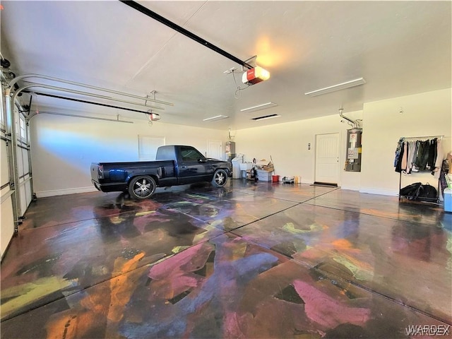 garage featuring a garage door opener, water heater, and baseboards