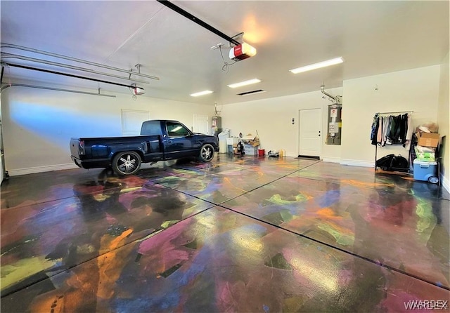 garage featuring a garage door opener, water heater, and baseboards