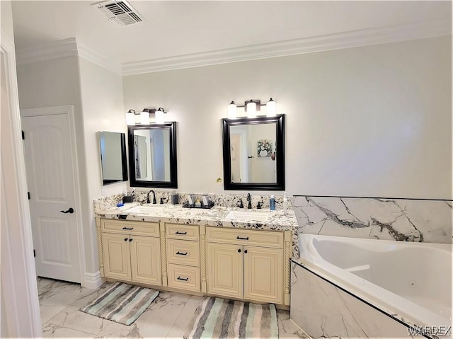 full bath with double vanity, ornamental molding, a garden tub, marble finish floor, and a sink