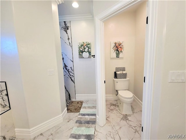 bathroom featuring marble finish floor, toilet, and baseboards