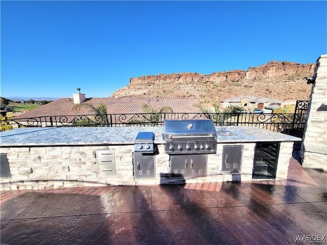 view of patio / terrace featuring grilling area, area for grilling, and a mountain view