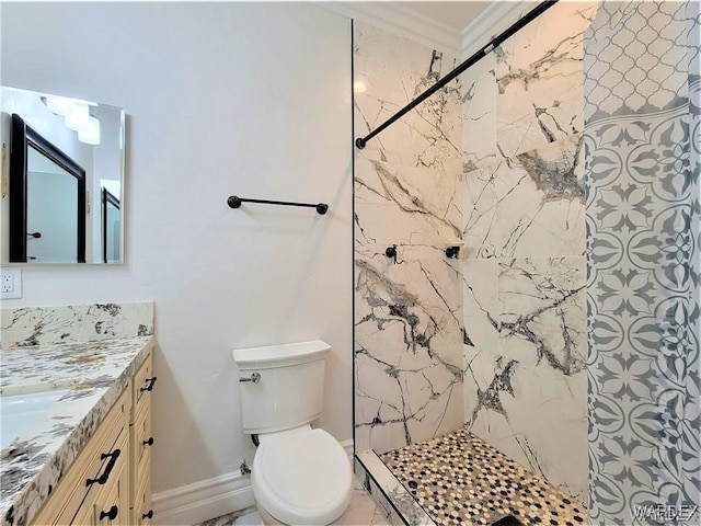 full bathroom with crown molding, toilet, vanity, tiled shower, and baseboards