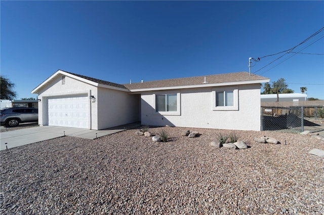 ranch-style house with a garage, concrete driveway, fence, and stucco siding