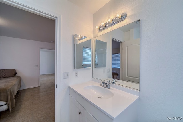 ensuite bathroom featuring visible vents, baseboards, connected bathroom, and vanity