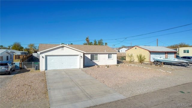 ranch-style house featuring concrete driveway, an attached garage, fence, and stucco siding