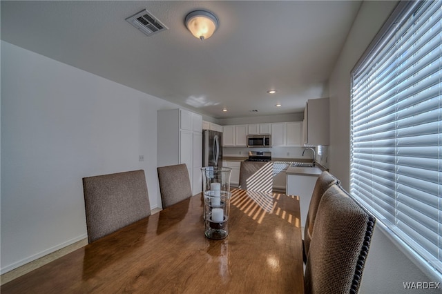 dining room with recessed lighting, visible vents, and baseboards