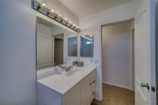 bathroom with baseboards and vanity