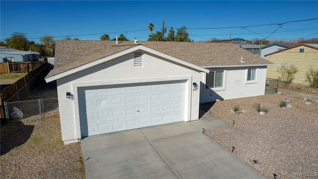 ranch-style home with driveway, a garage, roof with shingles, fence, and stucco siding