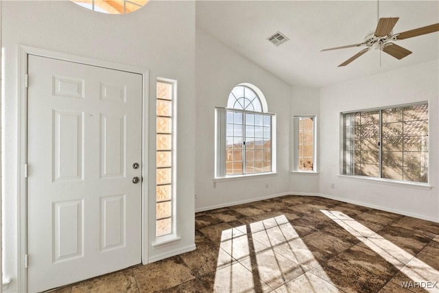 foyer entrance with lofted ceiling, ceiling fan, visible vents, and baseboards