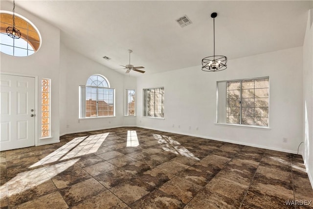 unfurnished living room featuring baseboards, visible vents, and ceiling fan with notable chandelier