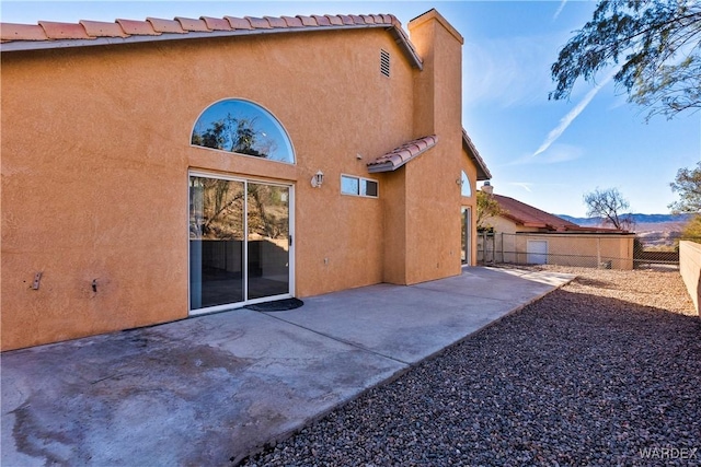 back of house featuring fence private yard, stucco siding, and a patio