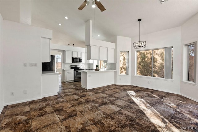 kitchen featuring stainless steel appliances, a peninsula, white cabinets, open floor plan, and decorative light fixtures