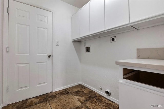 laundry area with washer hookup, cabinet space, stone finish floor, hookup for an electric dryer, and baseboards