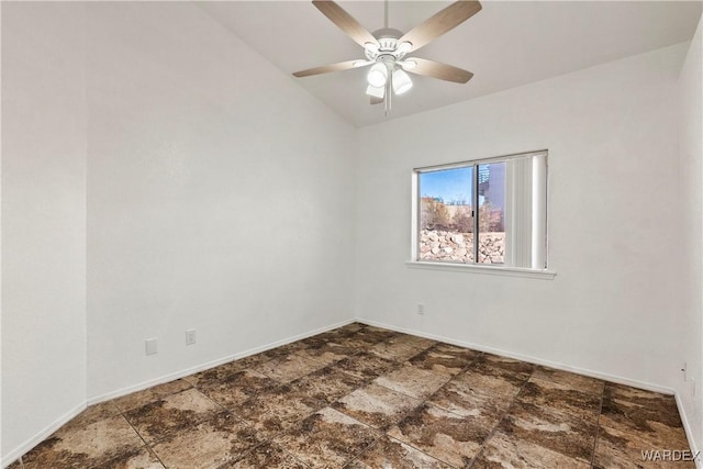 spare room featuring lofted ceiling, a ceiling fan, and baseboards