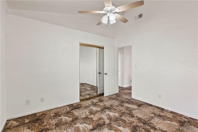 empty room with stone finish floor, visible vents, ceiling fan, and baseboards