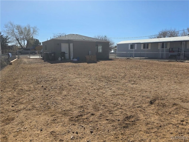 back of house with fence