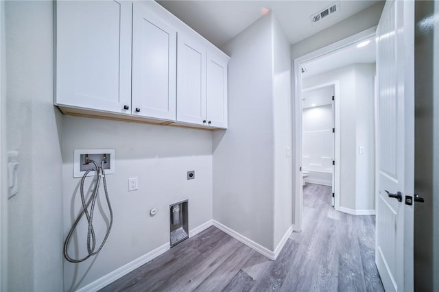6102 S Scorpion Ln, Fort Mohave, AZ 86426 - laundry area featuring cabinet space, hookup for a washing machine, wood finished floors, and gas dryer hookup