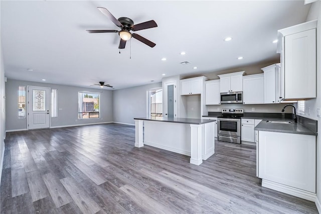 6102 S Scorpion Ln, Fort Mohave, AZ 86426 - kitchen featuring stainless steel appliances, dark countertops, ceiling fan, open floor plan, and recessed lighting