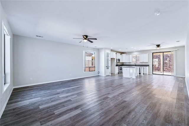 6102 S Scorpion Ln, Fort Mohave, AZ 86426 - unfurnished living room with a ceiling fan, dark wood-type flooring, and recessed lighting