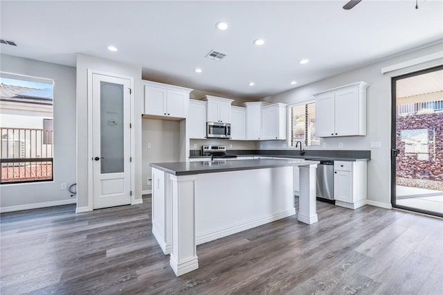 6102 S Scorpion Ln, Fort Mohave, AZ 86426 - kitchen featuring stainless steel appliances, dark countertops, white cabinetry, dark wood-style floors, and recessed lighting