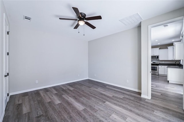 6102 S Scorpion Ln, Fort Mohave, AZ 86426 - empty room with a ceiling fan, wood finished floors, and recessed lighting