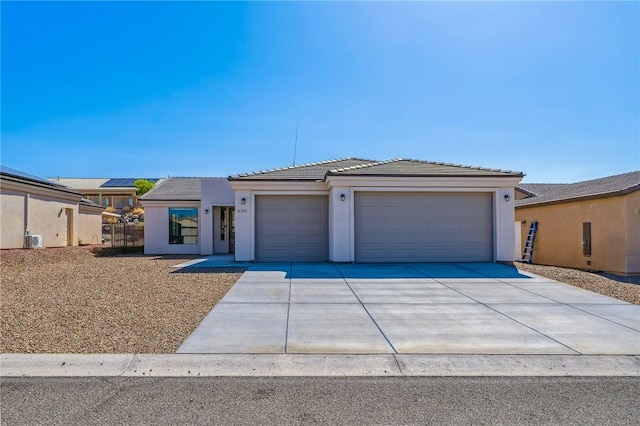 6102 S Scorpion Ln, Fort Mohave, AZ 86426 - view of front of house with an attached garage, driveway, stucco siding, and a tiled roof