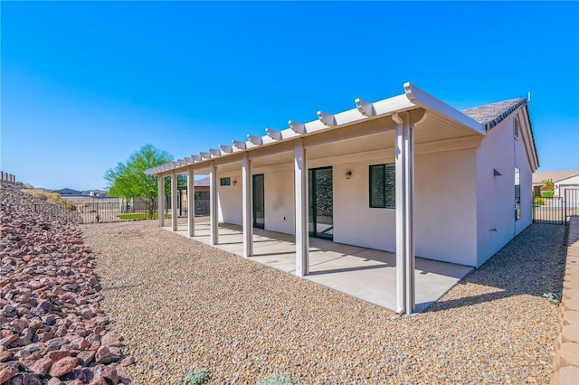 6102 S Scorpion Ln, Fort Mohave, AZ 86426 - rear view of house featuring stucco siding and a patio area