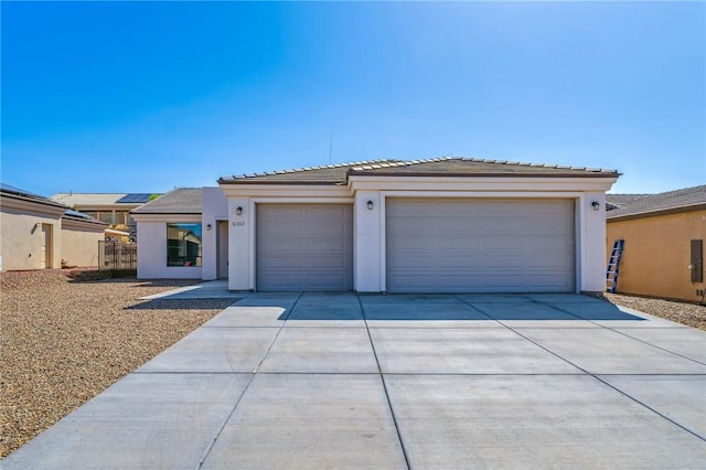 6102 S Scorpion Ln, Fort Mohave, AZ 86426 - view of front facade with driveway, stucco siding, a garage, and a tile roof