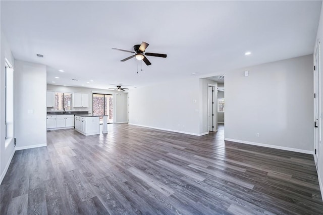 6102 S Scorpion Ln, Fort Mohave, AZ 86426 - unfurnished living room with a ceiling fan, dark wood finished floors, and recessed lighting