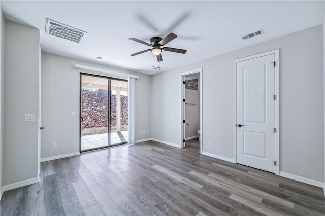 6102 S Scorpion Ln, Fort Mohave, AZ 86426 - unfurnished bedroom featuring access to exterior, wood finished floors, and a ceiling fan