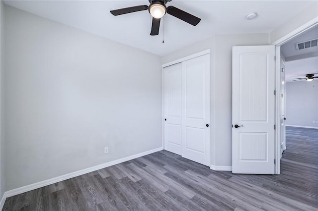 6102 S Scorpion Ln, Fort Mohave, AZ 86426 - unfurnished bedroom featuring wood finished floors, a closet, and ceiling fan