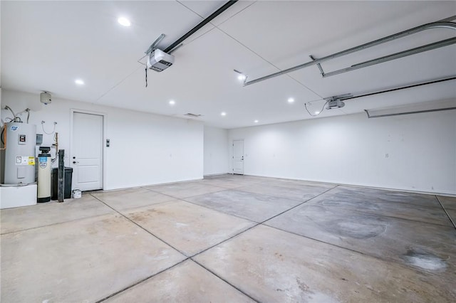 6102 S Scorpion Ln, Fort Mohave, AZ 86426 - garage with water heater, a garage door opener, and recessed lighting